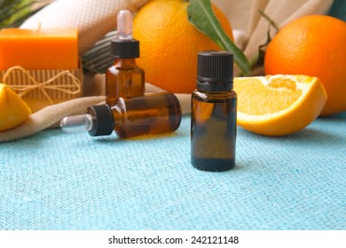 A Dropper Bottle Of Sweet Orange Essential Oil. Oranges In The Background