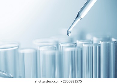 Dropper drop chemical into test tube , science or medical research concept