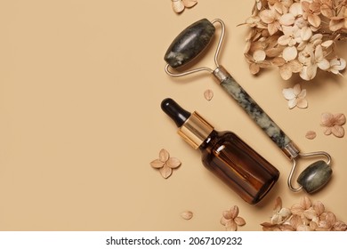 Dropper Glass Bottle Mockup, Face Roller And Dry Flowers On Beige Background. Natural Skincare Beauty Product