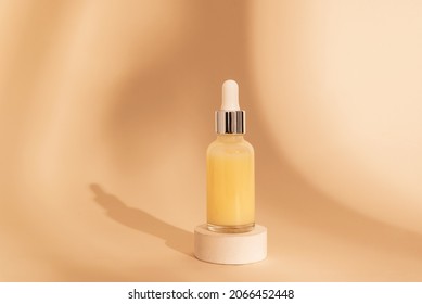 Dropper Glass Bottle Mockup. Сosmetic Pipette On Beige Background With Shadows On Stone Round Podium. Essential Oil