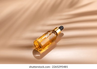 Dropper glass Bottle Mock-Up. dropper pipette with serum or essential oil on beige backgound with caustic shadows for product presentation. Skincare cosmetic. Beauty concept for face body care. - Shutterstock ID 2265295481