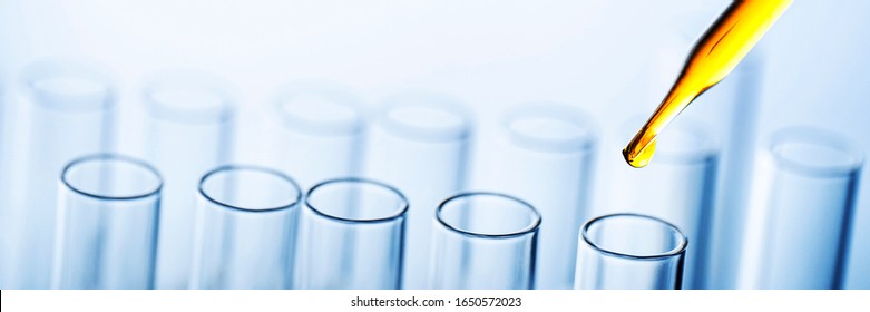 Dropping yellow chemical liquid or essential oil to test tube on white background, lab research and development concept.	
 - Powered by Shutterstock