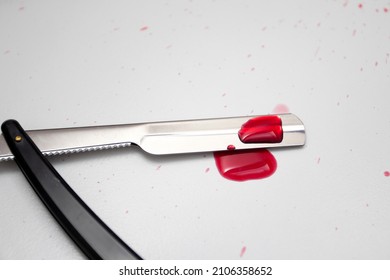 Drops Of Blood On A Straight Razor.