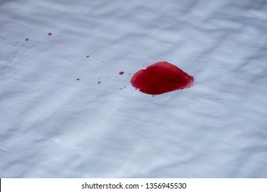 Drops Of Blood On A White Cloth Background.