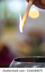 A Drops Of Melting Wax Upside Down With Blur Circle Bokeh In Religious Event