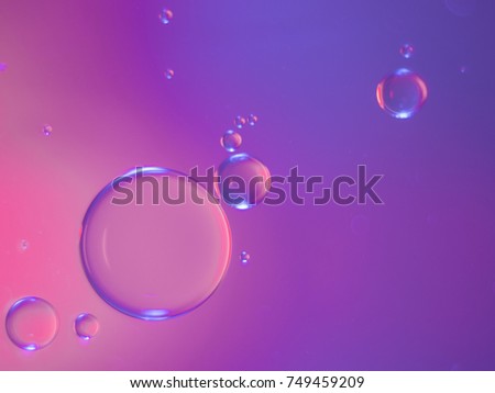 Drops of oil floating in water.