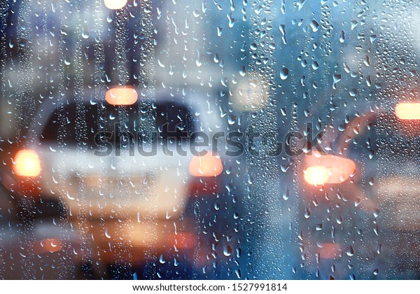drops on
glass auto road rain autumn night / abstract autumn background in
the city, auto traffic, romantic trip by
car