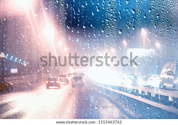 drops on\
glass auto road rain autumn night / abstract autumn background in\
the city, auto traffic, romantic trip by\
car