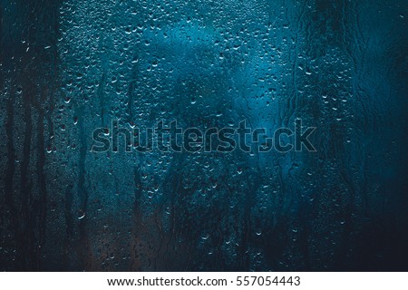 drops on glass , window condensation , and the background for dark text , spray on the window