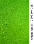 Drops on green background. Water drops on green tone background. Lime Abstarct Green lime wet texture with bubbles. Raindrop close up, pure water droplets condensed for creative banner design. 