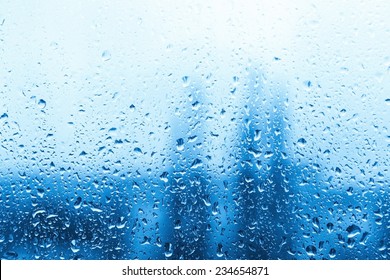 Drops Of Rain On Blue Glass Background