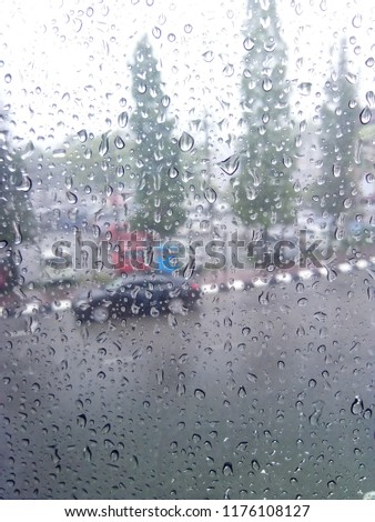 Similar – Rainy day I View through a wet window pane onto a busy street