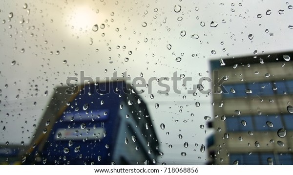 Drops of rain on a car\
window.