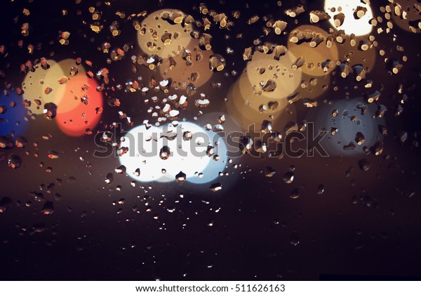 drops of rain on window rain blurred city abstract\
bokeh lights
