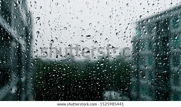 Drops of
rain on a window pane, Torrential rain
day.