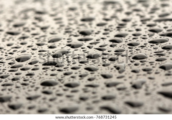 Drops of Rain or\
Water Drop on the Hood of the Car. Rain Drops on the Surface of the\
Car or on the Iron Surface Flow Down. Abstract Background and Water\
Texture for Design.