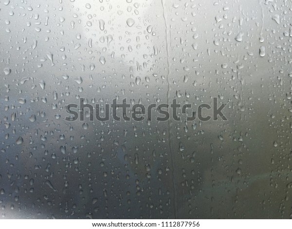 drops of rain water on\
metal