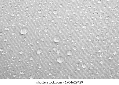 drops of rain water on white background. raindrop on umbrella