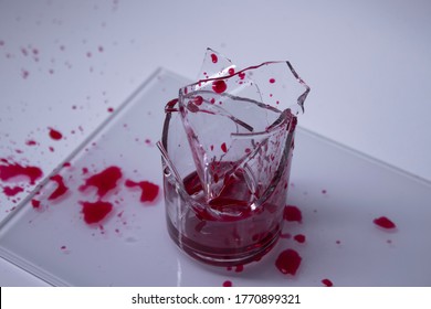 shattered glass on the floor with blood