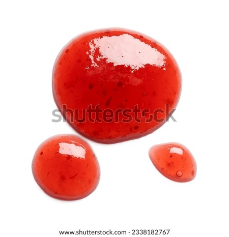 Drops of sweet strawberry jam on white background