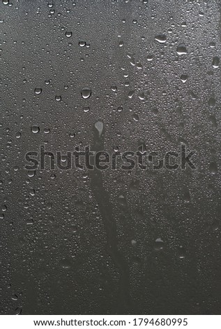 drops of water behind the window glass.