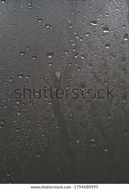 drops of water behind\
the window glass.