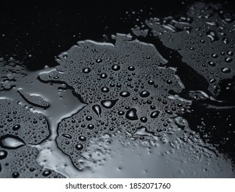 Drops Of Water On A Black Plastic Surface