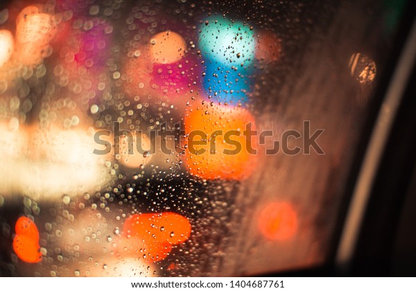 Drops of water on the\
car glass at night