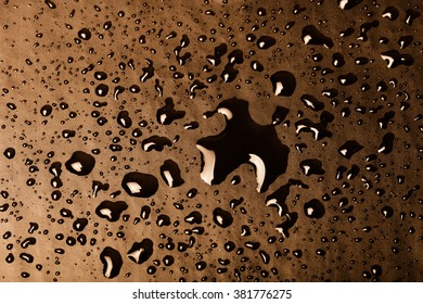 Drops of water on a color background. Gold. Toned.