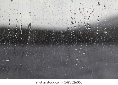 Drops of water on the glass. Background of water drops flowing down the glass