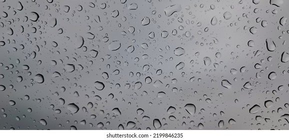 Drops Of Water On Glass. Raindrops On Glass. Raindrops Roll Down The Window. Water Splash. Wet Texture. Rain Texture. Beautiful Background. Sparkling Raindrop. Macro Photography Of A Drop Of Water.