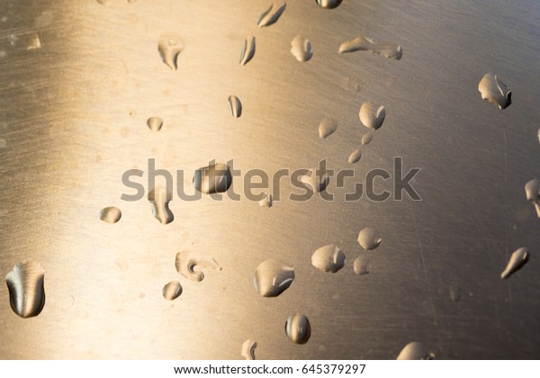 Drops of water on a metal\
surface