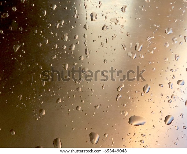 Drops of water on a metal\
surface
