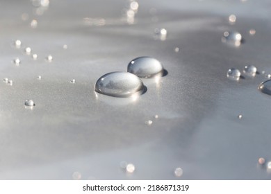 Drops Of Water On Metallic Waterproof Paper. Liquid Texture Wallpaper.