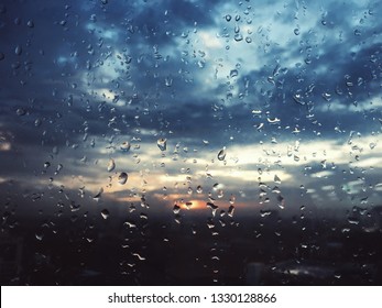 Drops of water on the window pane during sunset