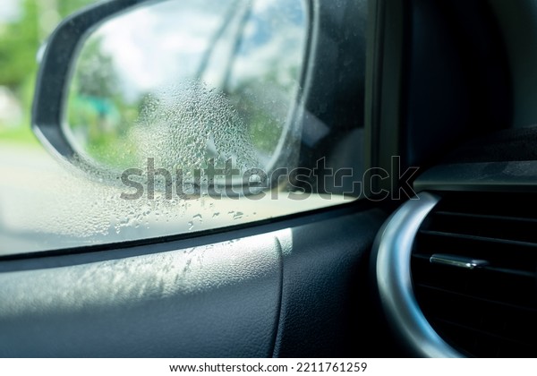 Drops of water on the windshield, water\
droplets are caused by the air inside the car cooler than the air\
outside the car, water vapor on the\
glass.