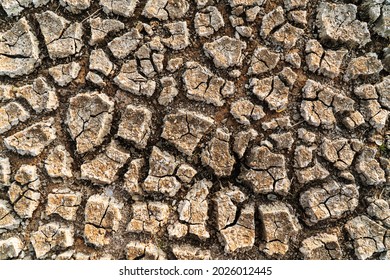 Drought Cracked Ground Earth On Top View. Crack Soil Surface Texture. Background On Hot Arid Climate Weather. Brown Broken Ground. Global Warming And Environmental Crisis.