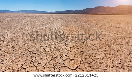 Drought dry cracked landscape with lakebed and dead riverbed due to water shortage and climate change