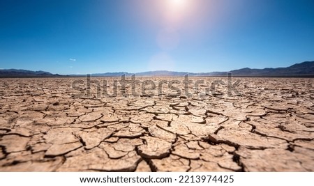 Drought dry cracked landscape with lakebed and dead riverbed due to water shortage and climate change