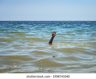 The drowning hand stretched out over the surface for help