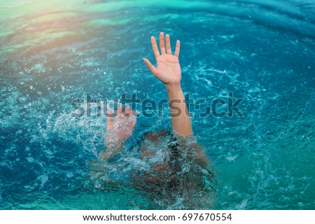 The drowning hand stretched out over the surface for help.