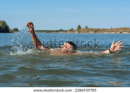 Drowning man in the river needs help.