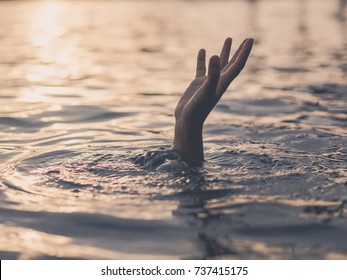 Drowning victims, hand of drowning man needing help. Failure and rescue concept.