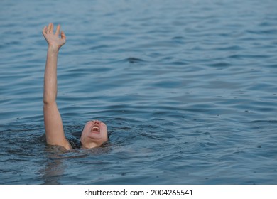 Drowning Woman Reaching For Help In Sea