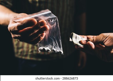 Drug addict buying narcotics and paying