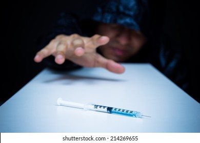 Drug Addict Craving Drugs, Syringe On Table