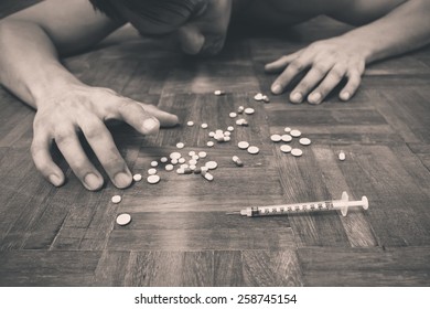 Drug Addict Craving Drugs And Syringe On Floor