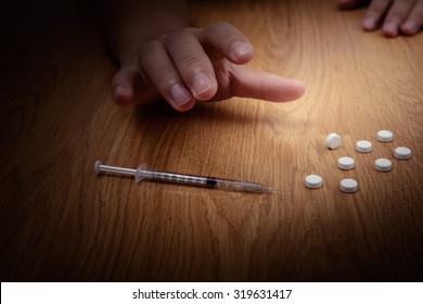 Drug Addict Is Craving Drugs And Syringe On Floor