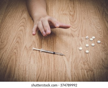 Drug Addict Is Craving Drugs And Syringe On Floor