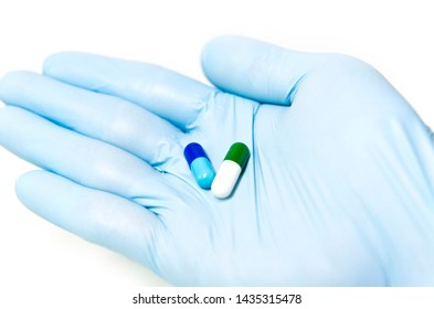 Drug Combination Therapy  For Orphan Diseases. Capsules On The Researcher’s Hand With Blue Glove.